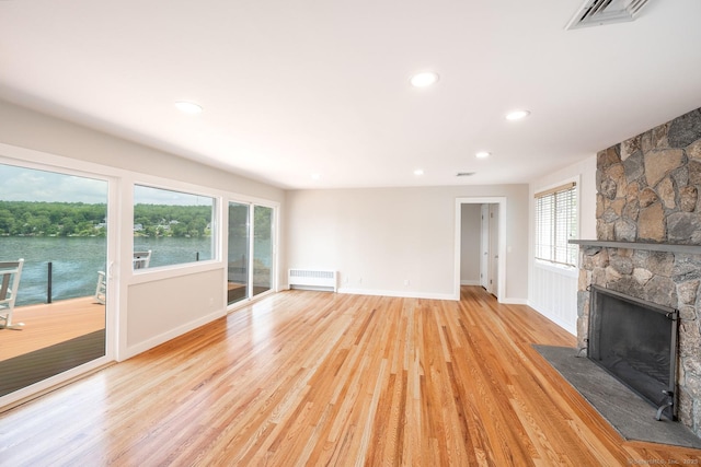 100 N Lake Shore Dr, Brookfield, CT 06804 - unfurnished living room featuring radiator heating unit, light wood-type flooring, a fireplace, plenty of natural light, and recessed lighting