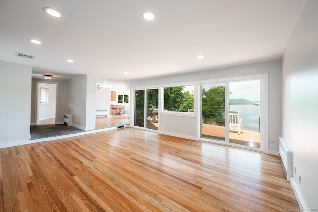 100 N Lake Shore Dr, Brookfield, CT 06804 - unfurnished living room with light wood-type flooring, plenty of natural light, radiator, and recessed lighting