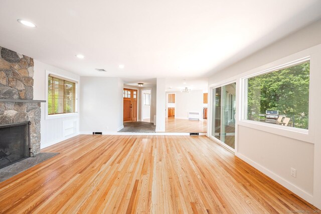100 N Lake Shore Dr, Brookfield, CT 06804 - unfurnished living room featuring wood finished floors, a stone fireplace, and recessed lighting