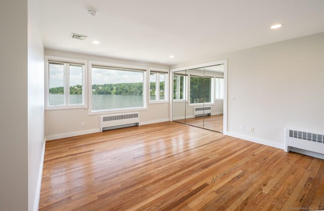 100 N Lake Shore Dr, Brookfield, CT 06804 - unfurnished room with radiator heating unit, wood finished floors, a smoke detector, and recessed lighting
