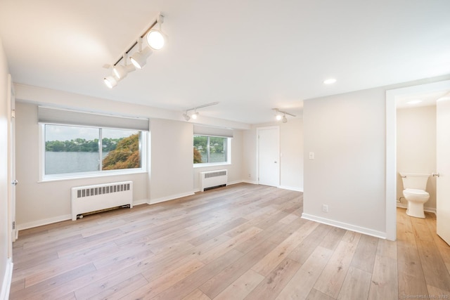 100 N Lake Shore Dr, Brookfield, CT 06804 - empty room with radiator, track lighting, light wood-style floors, and recessed lighting