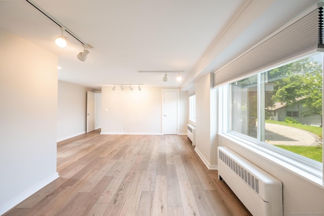 100 N Lake Shore Dr, Brookfield, CT 06804 - spare room with rail lighting, radiator, healthy amount of natural light, and light wood-style flooring