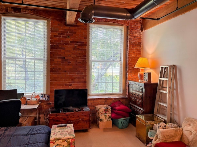 92 Main St Apt 102, Deep River, CT 06417 - living area with healthy amount of natural light, brick wall, carpet flooring, and beamed ceiling