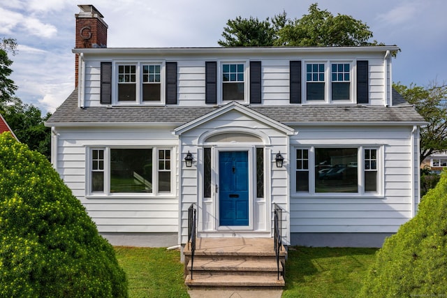 19 Robert St, Hamden, CT 06514 - view of front of property with roof with shingles, a chimney, and a front lawn