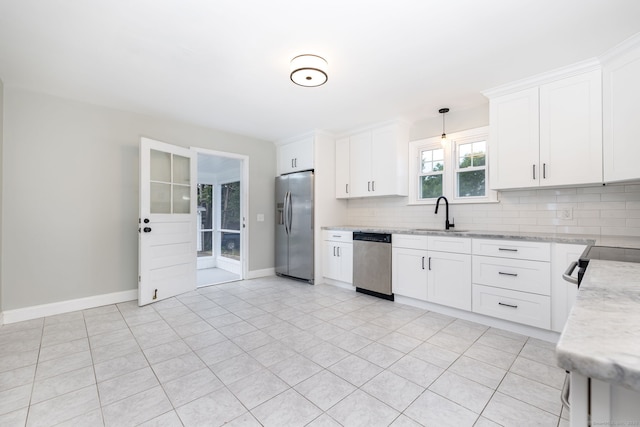 19 Robert St, Hamden, CT 06514 - kitchen with appliances with stainless steel finishes, decorative backsplash, white cabinetry, and light stone countertops