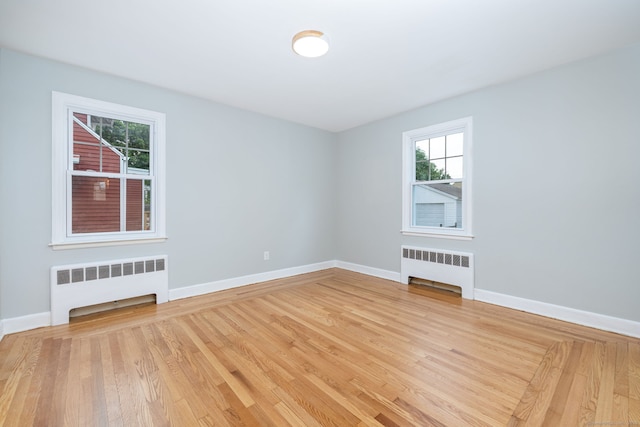 19 Robert St, Hamden, CT 06514 - spare room featuring radiator, plenty of natural light, and light wood finished floors