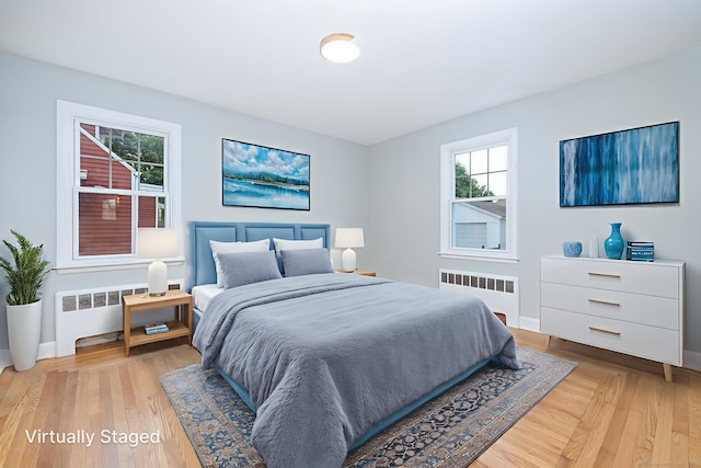 19 Robert St, Hamden, CT 06514 - bedroom with radiator, multiple windows, and light wood-type flooring
