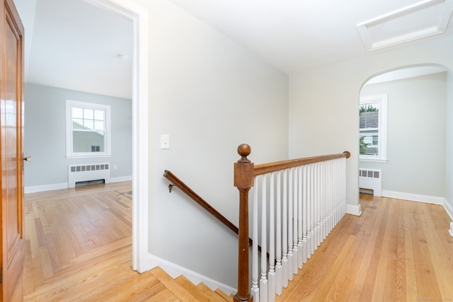 19 Robert St, Hamden, CT 06514 - hall with radiator heating unit, an upstairs landing, and light wood-style floors