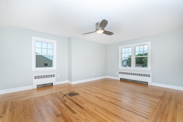 19 Robert St, Hamden, CT 06514 - spare room with radiator, light wood-style flooring, and ceiling fan