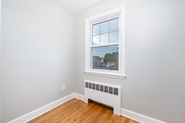 19 Robert St, Hamden, CT 06514 - unfurnished room featuring radiator and light wood finished floors