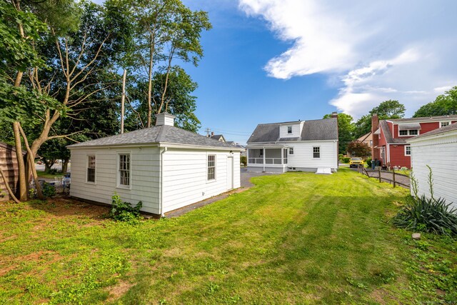 19 Robert St, Hamden, CT 06514 - rear view of house with a chimney, a shingled roof, and an outdoor structure