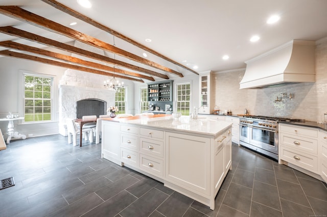 509 Main St N, Woodbury, CT 06798 - kitchen featuring range with two ovens, recessed lighting, custom exhaust hood, white cabinets, and beam ceiling