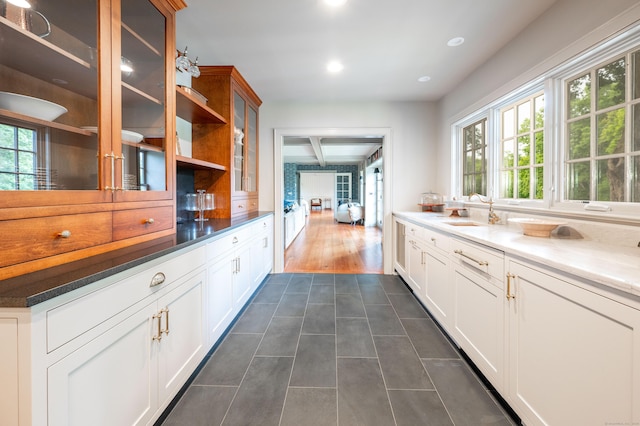 509 Main St N, Woodbury, CT 06798 - kitchen with glass insert cabinets, dark tile patterned flooring, recessed lighting, white cabinets, and beam ceiling