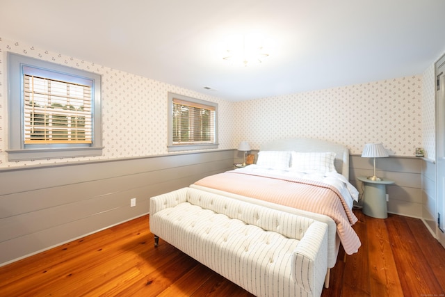509 Main St N, Woodbury, CT 06798 - bedroom with wallpapered walls, wainscoting, and wood finished floors