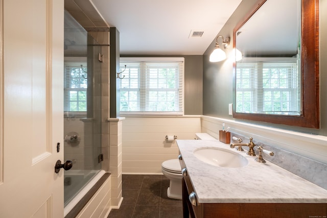 509 Main St N, Woodbury, CT 06798 - bathroom featuring tile patterned flooring, vanity, combined bath / shower with glass door, and a wainscoted wall