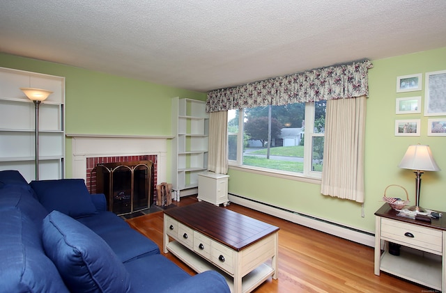 134 Valley Crest Dr, Wethersfield, CT 06109 - living area featuring a baseboard heating unit, wood finished floors, a fireplace, and a textured ceiling