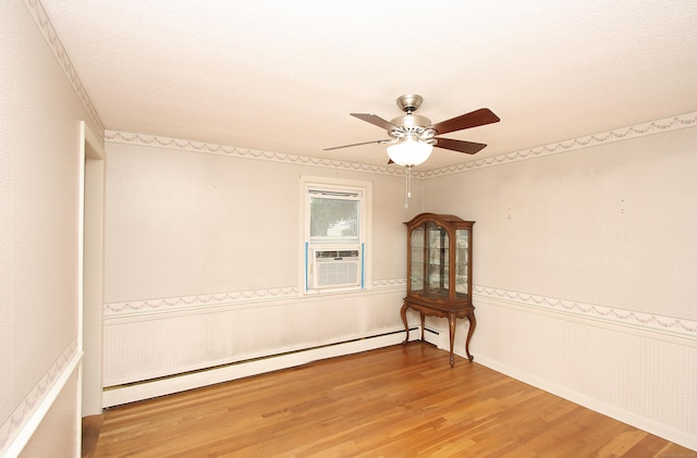 134 Valley Crest Dr, Wethersfield, CT 06109 - unfurnished room featuring a baseboard heating unit, wood finished floors, a ceiling fan, cooling unit, and wainscoting