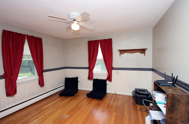 134 Valley Crest Dr, Wethersfield, CT 06109 - unfurnished office with a baseboard radiator, wood finished floors, wallpapered walls, and ceiling fan