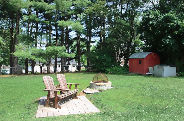 134 Valley Crest Dr, Wethersfield, CT 06109 - view of yard featuring a fire pit and a storage unit