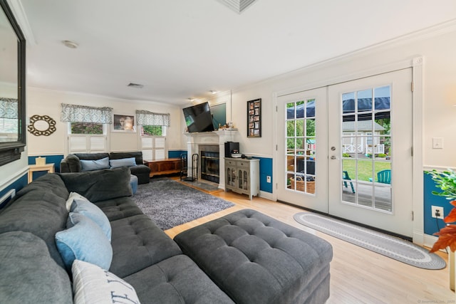 2 Bronson Rd, Prospect, CT 06712 - living area featuring crown molding, french doors, wood finished floors, healthy amount of natural light, and a fireplace
