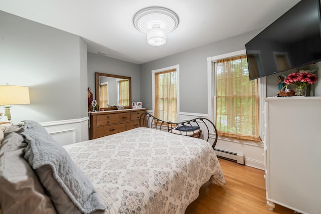 2 Bronson Rd, Prospect, CT 06712 - bedroom with light wood-style flooring, baseboard heating, and wainscoting