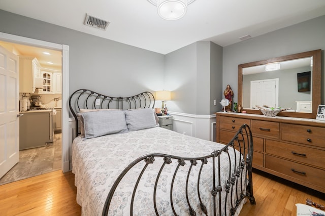 2 Bronson Rd, Prospect, CT 06712 - bedroom featuring light wood finished floors, wainscoting, and a decorative wall