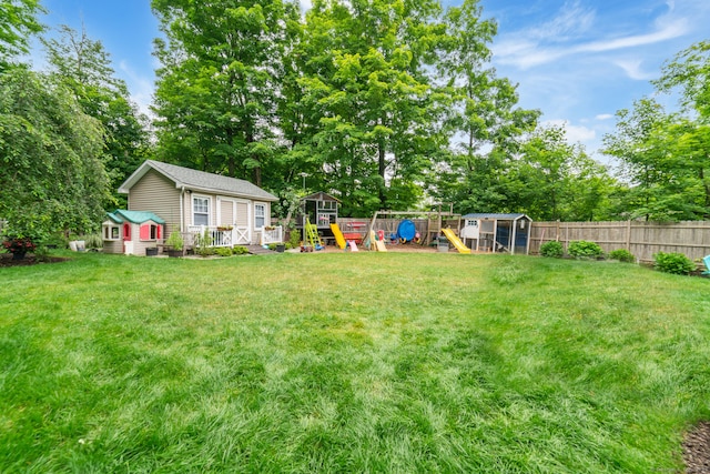 2 Bronson Rd, Prospect, CT 06712 - view of yard with an outdoor structure, view of wooded area, a playground, and a wooden deck