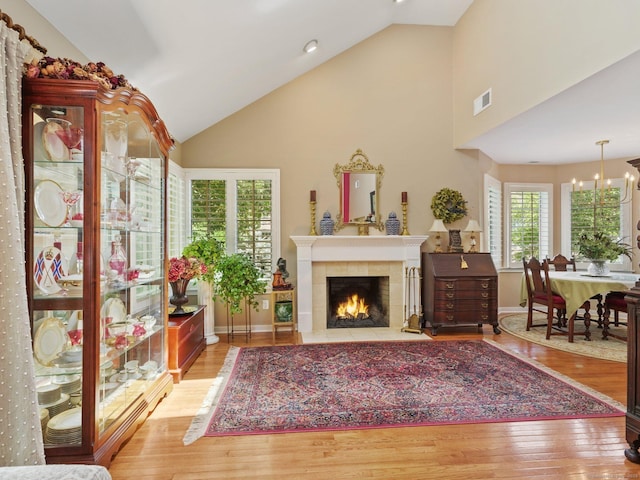 51 Hale Ln Unit 51, Darien, CT 06820 - living room with wood finished floors, a tile fireplace, high vaulted ceiling, and a chandelier