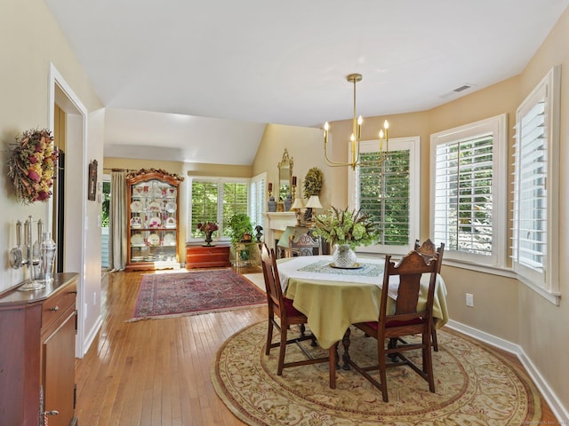 51 Hale Ln Unit 51, Darien, CT 06820 - dining area with a chandelier, light wood finished floors, and vaulted ceiling