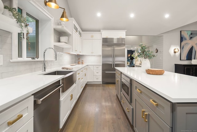 3663 Congress St, Fairfield, CT 06824 - kitchen with built in appliances, decorative backsplash, light countertops, white cabinets, and recessed lighting
