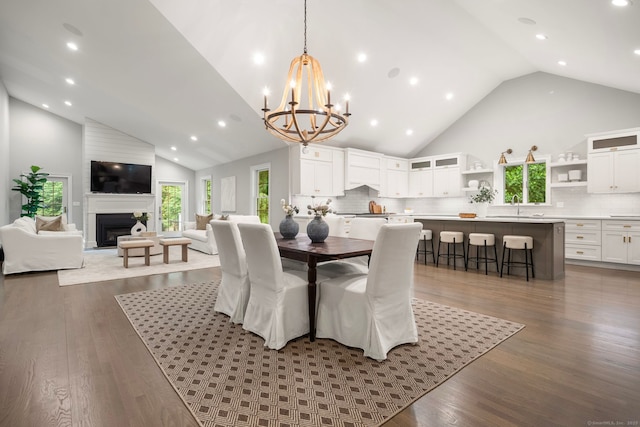 3663 Congress St, Fairfield, CT 06824 - dining space featuring high vaulted ceiling, healthy amount of natural light, a chandelier, wood finished floors, and recessed lighting