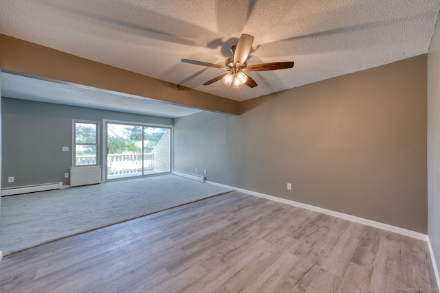 118 Sheraton Ln Unit 118, Norwich, CT 06360 - empty room with baseboard heating, a textured ceiling, a ceiling fan, light wood-style floors, and a baseboard heating unit