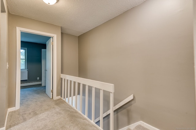 118 Sheraton Ln Unit 118, Norwich, CT 06360 - corridor with an upstairs landing, a baseboard heating unit, carpet, and a textured ceiling