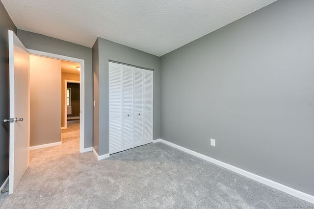 118 Sheraton Ln Unit 118, Norwich, CT 06360 - unfurnished bedroom with carpet floors, a closet, and a textured ceiling