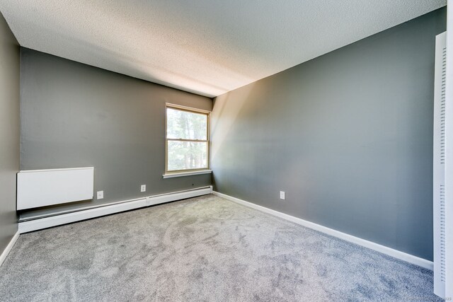 118 Sheraton Ln Unit 118, Norwich, CT 06360 - carpeted spare room featuring baseboard heating and a textured ceiling