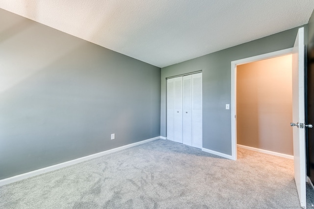 118 Sheraton Ln Unit 118, Norwich, CT 06360 - unfurnished bedroom featuring carpet flooring, a closet, and a textured ceiling
