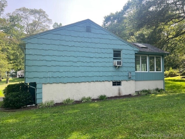 35 Corey Ln, East Lyme, CT 06357 - view of side of home featuring a lawn, cooling unit, and a sunroom