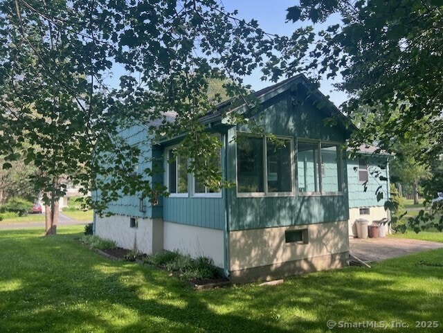35 Corey Ln, East Lyme, CT 06357 - view of property exterior featuring a yard and a sunroom