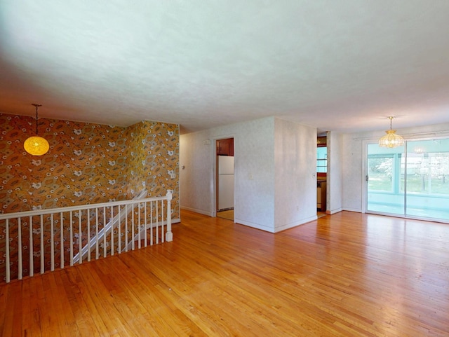 35 Corey Ln, East Lyme, CT 06357 - unfurnished room featuring light wood-style floors and a chandelier