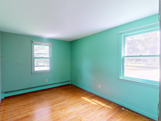 35 Corey Ln, East Lyme, CT 06357 - unfurnished room with a baseboard heating unit and light wood-style flooring