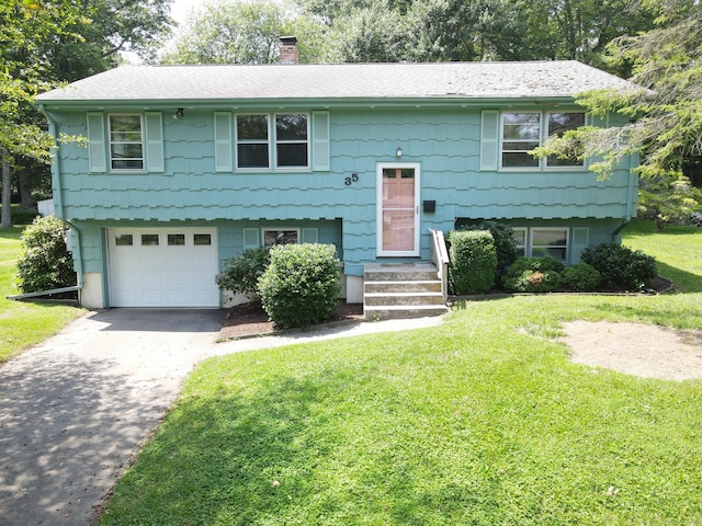 35 Corey Ln, East Lyme, CT 06357 - bi-level home with a chimney, a front yard, driveway, and an attached garage