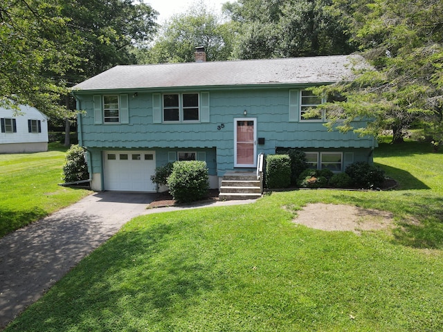 35 Corey Ln, East Lyme, CT 06357 - bi-level home featuring a chimney, asphalt driveway, an attached garage, and a front lawn