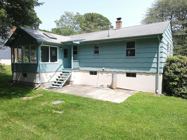 35 Corey Ln, East Lyme, CT 06357 - rear view of house with a chimney, a shingled roof, a patio, and a yard
