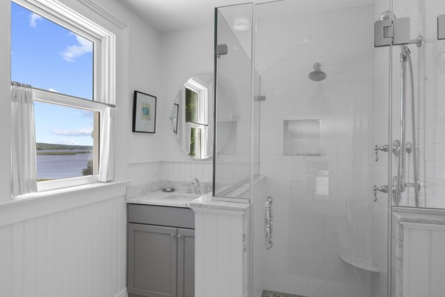 1 Foxboro Rd, Essex, CT 06426 - bathroom featuring a shower stall, vanity, wainscoting, and a water view