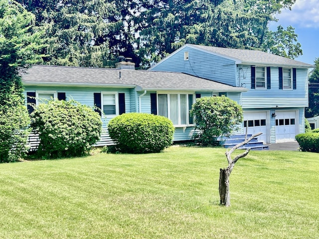 239 Bates Dr, Cheshire, CT 06410 - tri-level home with a garage, a front lawn, asphalt driveway, a chimney, and a shingled roof