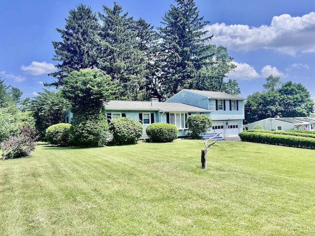 239 Bates Dr, Cheshire, CT 06410 - split level home with an attached garage, a front lawn, and a chimney