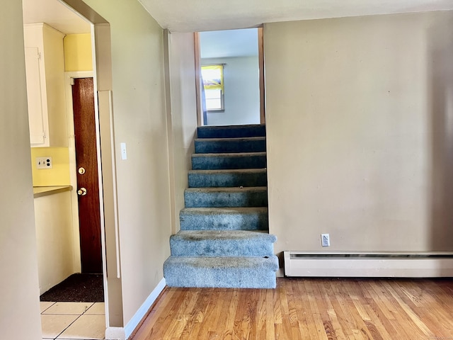 239 Bates Dr, Cheshire, CT 06410 - stairway featuring baseboard heating and wood finished floors