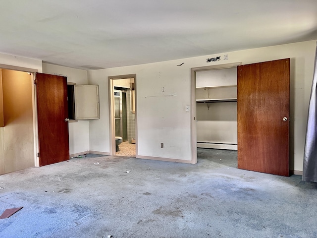 239 Bates Dr, Cheshire, CT 06410 - unfurnished bedroom with a baseboard radiator, carpet flooring, ensuite bath, and a spacious closet