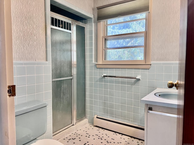 239 Bates Dr, Cheshire, CT 06410 - bathroom featuring a baseboard heating unit, tile walls, a stall shower, vanity, and wainscoting