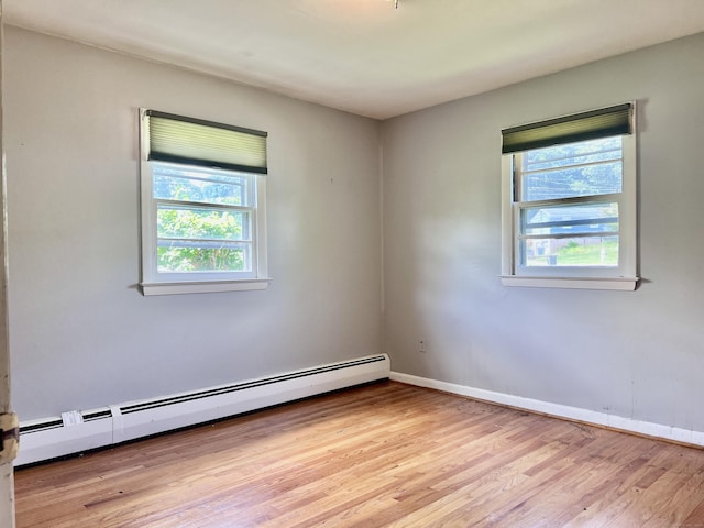 239 Bates Dr, Cheshire, CT 06410 - spare room featuring baseboard heating, plenty of natural light, and light wood-style flooring